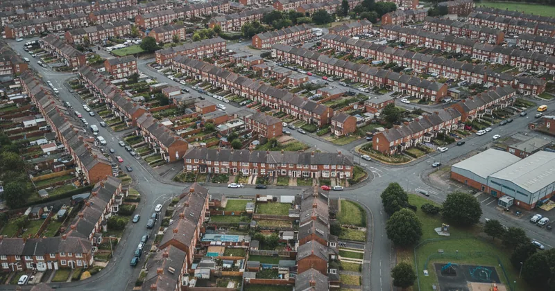 aerial photograph of a generic UK city neighbourhood with terraced housing and streets, overcast
