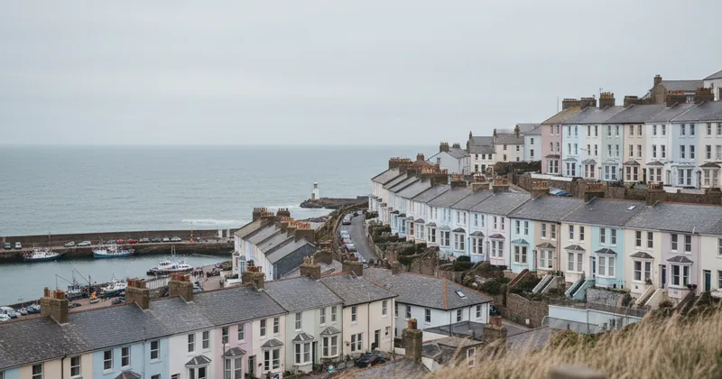 UK coastal town view with pastel houses and a grey sky, wide shot